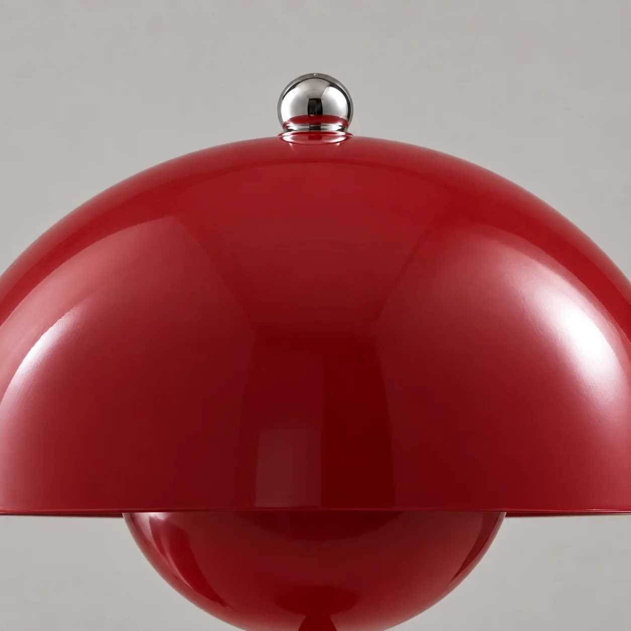 Silver ball finial on a burgundy lamp shade